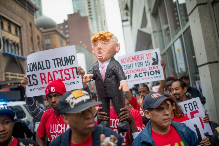 Demonstrators hold up a piñata of Republican Presidential candidate Donald Trump during a protest on October 12, 2015 in Chicago, Illinois. (GETTY IMAGES)