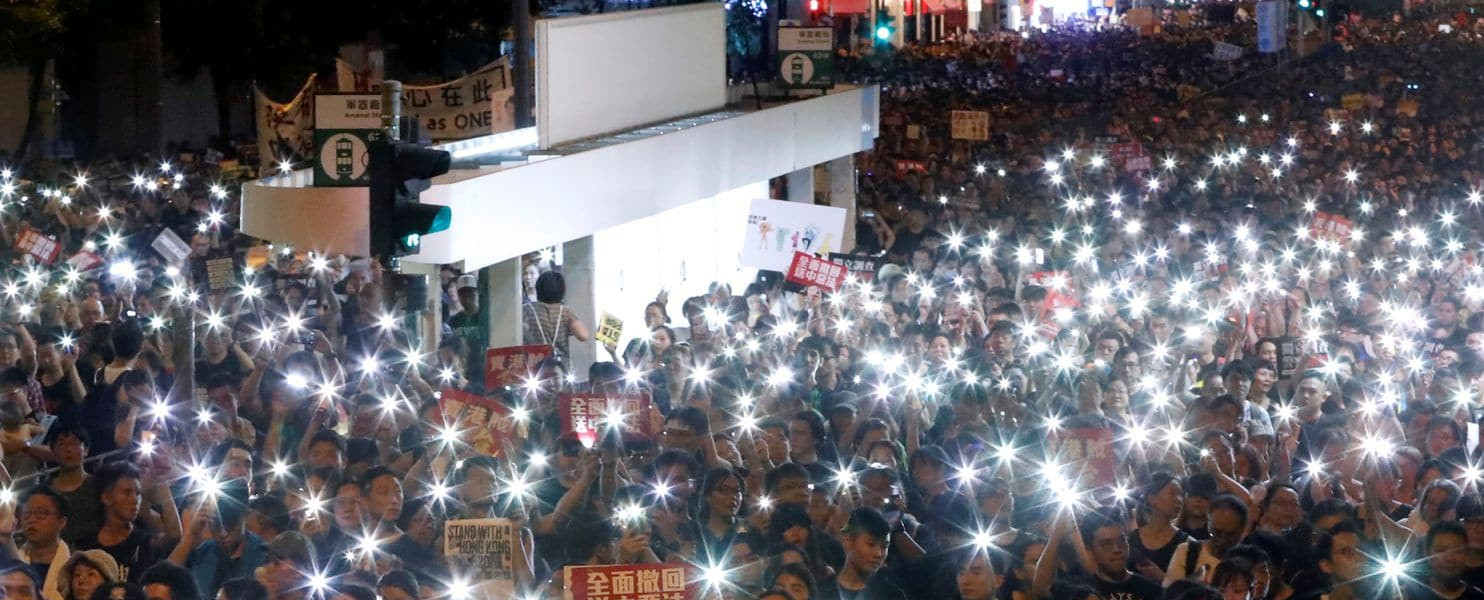 Protesters in Hong Kong use the flashlights from their phones as they march on July 1, 2019 as part of the anti-extradition bill protests. (Tyrone Siu/Reuters)