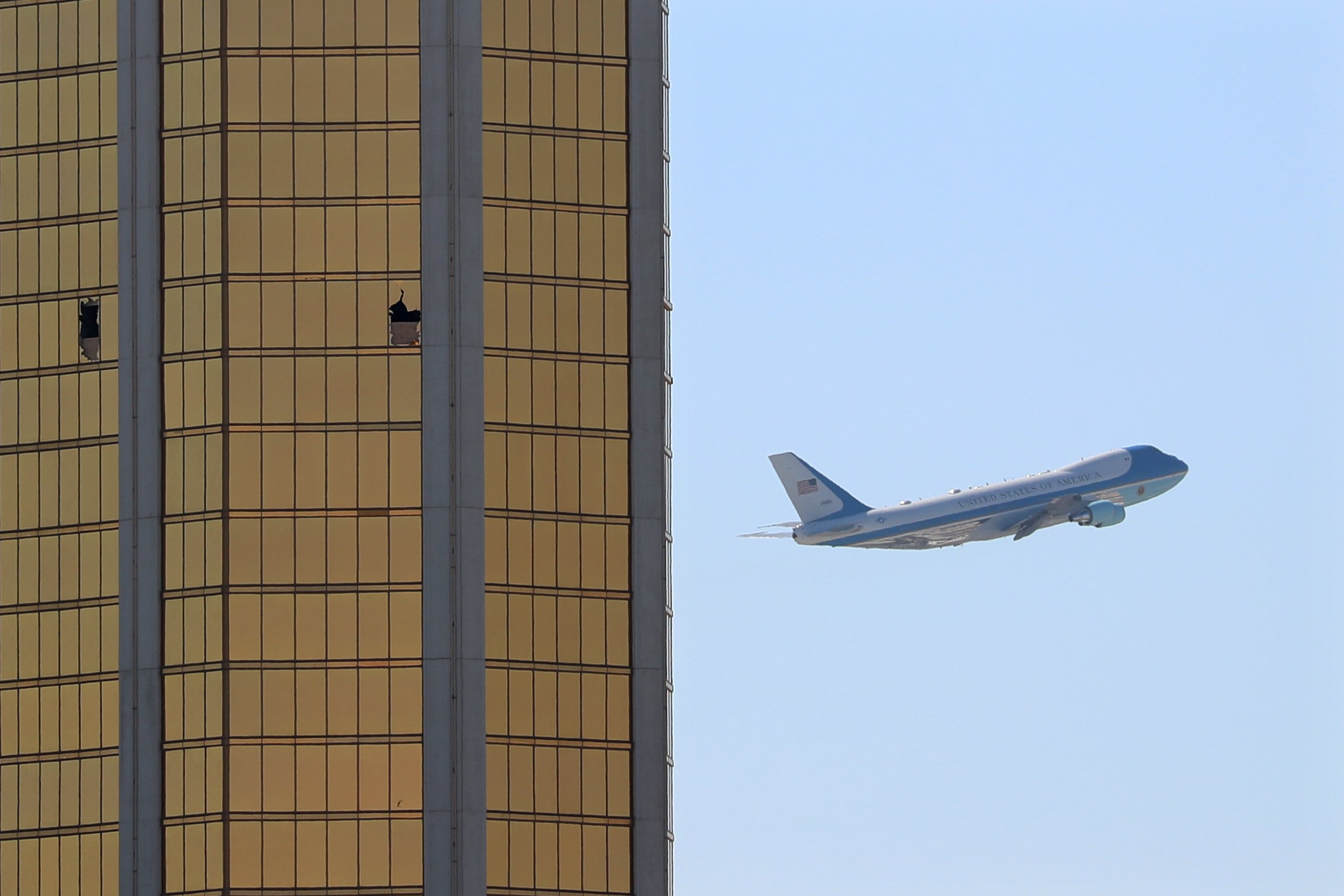 Air Force One departs Las Vegas on Wednesday, flying past the broken windows on the Mandalay Bay Resort and Casino. (Mike Blake/Reuters)